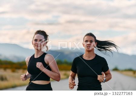 Two Friends Running Together on a Sunny Day, Preparing for Life's Extreme Challenges 132277163