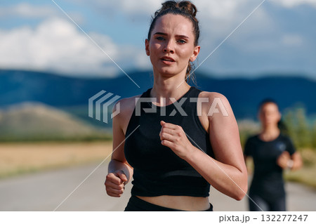 Two Friends Running Together on a Sunny Day, Preparing for Life's Extreme Challenges Two Friends Running Together on a Sunny Day, Preparing for Life's Extreme Challenges 132277247