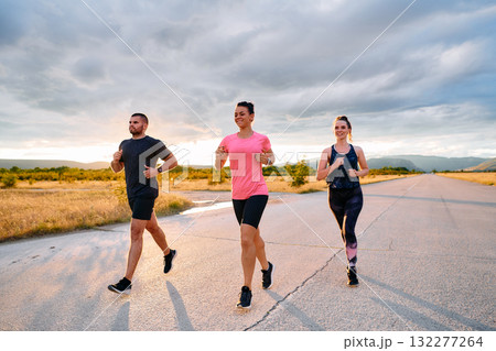 Athlete Leading Group Run at Sunset Amidst Stunning Nature 132277264
