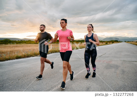 Athlete Leading Group Run at Sunset Amidst Stunning Nature Athlete Leading Group Run at Sunset Amidst Stunning Nature 132277268