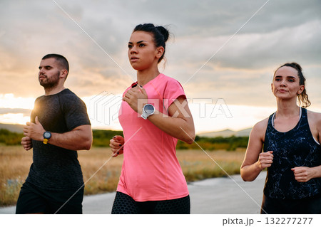 Athlete Leading Group Run at Sunset Amidst Stunning Nature Athlete Leading Group Run at Sunset Amidst Stunning Nature 132277277