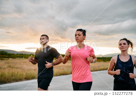 Athlete Leading Group Run at Sunset Amidst Stunning Nature Athlete Leading Group Run at Sunset Amidst Stunning Nature 132277278