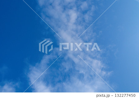 White clouds on blue sky. Fluffy cirrus clouds in summer sunny day. Nature cloudscape background. White clouds on blue sky. Fluffy cirrus clouds in summer sunny day. Nature cloudscape background. 132277450