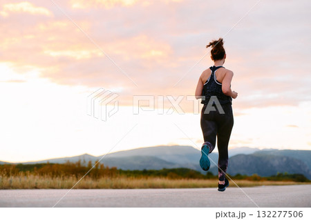 Determined Athlete Running in the Sun amidst Beautiful Nature Determined Athlete Running in the Sun amidst Beautiful Nature 132277506