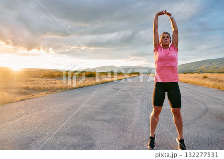 Athlete Stretching at Sunset After Intense Run 132277531