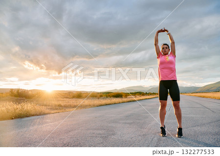 Athlete Stretching at Sunset After Intense Run Athlete Stretching at Sunset After Intense Run 132277533