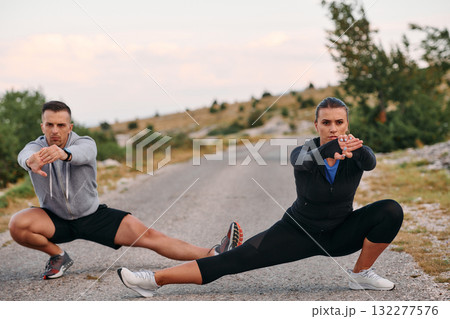 Romantic Couple Stretching Together After an Intense Morning Run Romantic Couple Stretching Together After an Intense Morning Run 132277576
