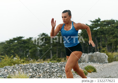 Unstoppable: A Determined Athlete Trains Through the Rain in Pursuit of Marathon Glory Unstoppable: A Determined Athlete Trains Through the Rain in Pursuit of Marathon Glory 132277621