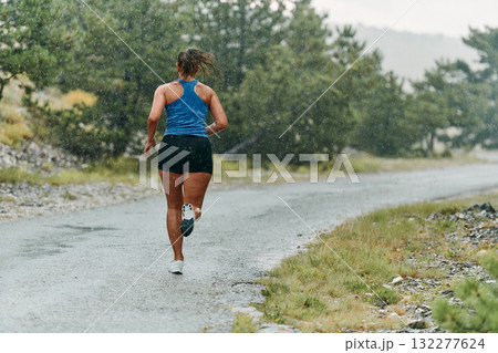 Unstoppable: A Determined Athlete Trains Through the Rain in Pursuit of Marathon Glory 132277624