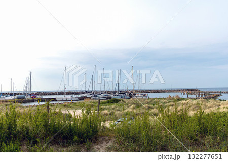 Sea pier with boats and yachts at sunset. Bornholm, Denmark Sea pier with boats and yachts at sunset. Bornholm, Denmark 132277651