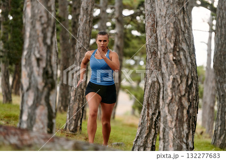 Fearless Woman Conquering Wooden Obstacles in the Dangerous Forest Terrain. Fearless Woman Conquering Wooden Obstacles in the Dangerous Forest Terrain. 132277683