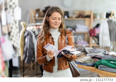 Young woman chooses socks in clothing store 132277733