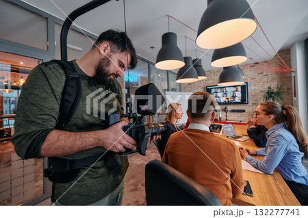 Capturing Corporate Dynamics: Videographer Films Business Meeting in Modern Office. 132277741