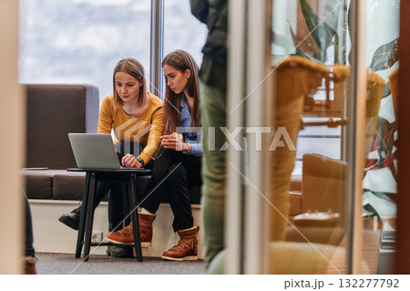 Business Colleagues Reviewing Work on Laptop During Break 132277792