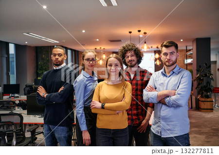 Portrait of successful creative business team looking at camera and smiling. Diverse business people standing together at startup. Selective focus Portrait of successful creative business team looking at camera and smiling. Diverse business people standing together at startup. Selective focus 132277811