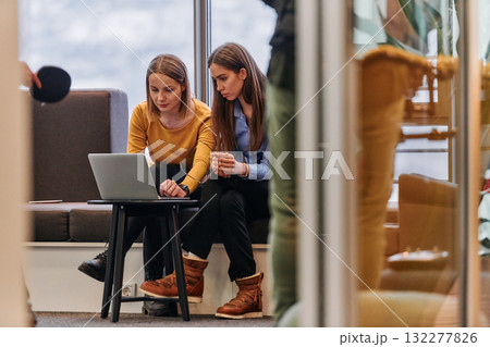Business Colleagues Reviewing Work on Laptop During Break 132277826