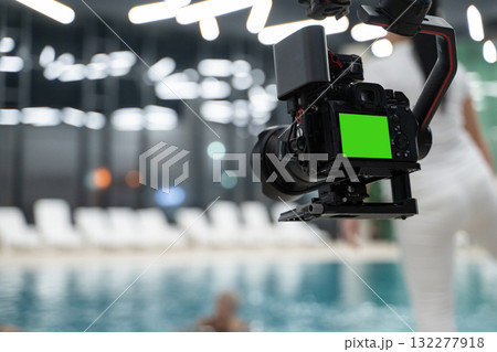 Professional Camera on Gimbal with Green Screen Display Filming Near Pool Professional Camera on Gimbal with Green Screen Display Filming Near Pool 132277918