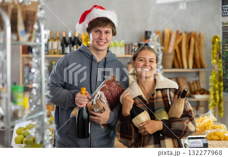 Couple man and woman choosing groceries in store 132277968
