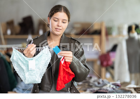 Uncertain young girl choosing panties in clothing store Uncertain young girl choosing panties in clothing store 132278036