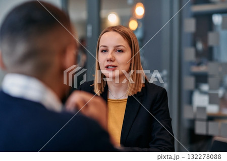 Businesswoman Leading Discussion in Modern Office Setting Businesswoman Leading Discussion in Modern Office Setting 132278088