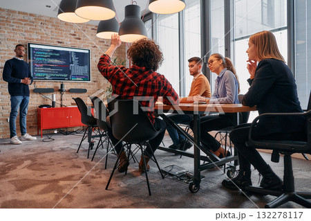 African-American businessman leads a meeting, passionately presenting a business plan to his attentive team, fostering collaboration and strategic thinking African-American businessman leads a meeting, passionately presenting a business plan to his attentive team, fostering collaboration and strategic thinking 132278117