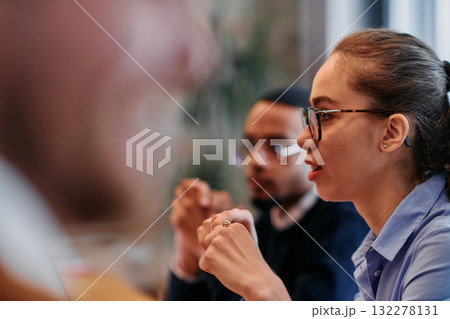 Businesswoman Leading Discussion in Modern Office Setting Businesswoman Leading Discussion in Modern Office Setting 132278131