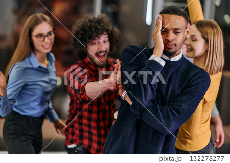 A group of young business people have fun playing interesting games while taking a break from work in a modern office. Selective focus A group of young business people have fun playing interesting games while taking a break from work in a modern office. Selective focus 132278277