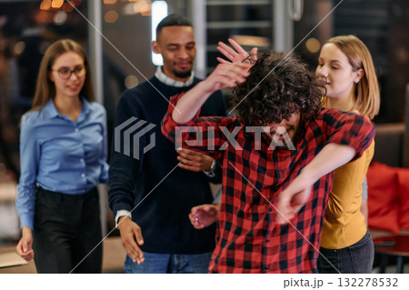 A group of young business people have fun playing interesting games while taking a break from work in a modern office. Selective focus A group of young business people have fun playing interesting games while taking a break from work in a modern office. Selective focus 132278532