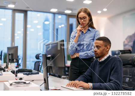Digital Collaboration: Blonde Businesswoman and African American Partner Reviewing Documents Online Digital Collaboration: Blonde Businesswoman and African American Partner Reviewing Documents Online 132278582