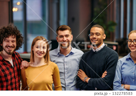 Portrait of successful creative business team looking at camera and smiling. Diverse business people standing together at startup. Selective focus Portrait of successful creative business team looking at camera and smiling. Diverse business people standing together at startup. Selective focus 132278583