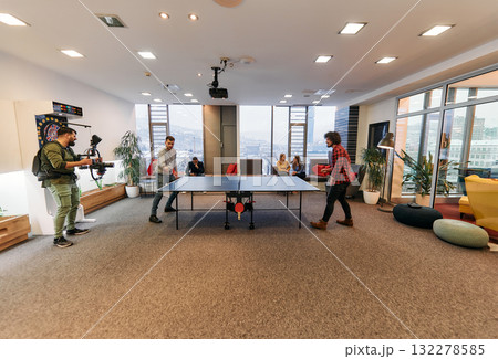 Videographer Captures Business Colleagues Playing Table Tennis During Break 132278585
