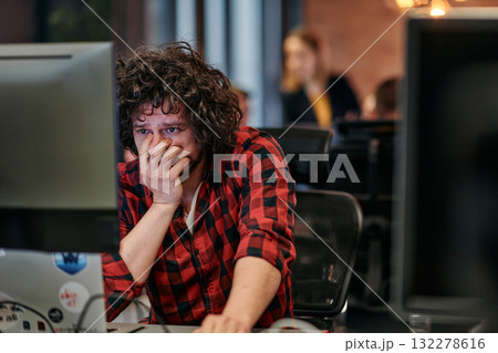 Disappointed Programmer with Messy Hair Looking at Computer Monitor in Office. 132278616