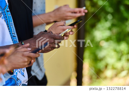 Diverse Teen Group Standing Together Against Wall Using Smartphones 132278814