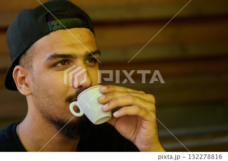 Close Up Portrait of Middle Eastern Teenager Enjoying a Coffee 132278816