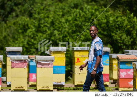 African American Teenager Exploring Small Beekeeping Businesses in Traditional Sudanese Attire amidst Nature 132278846