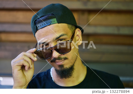 Close Up Portrait of Smiling Sudanese Teenager with Broad Smile, Chin, and Cap 132278894