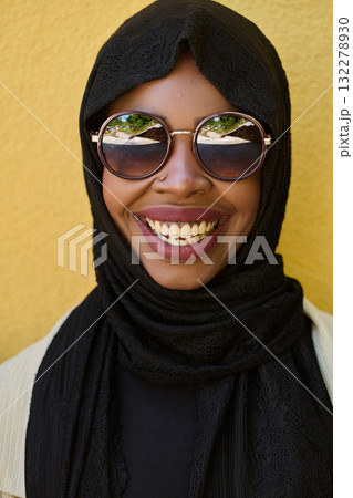 Close Up Portrait of Middle Eastern Muslim Woman Against Yellow Background 132278930