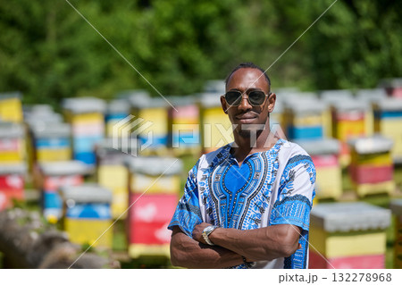 African American Teenager Exploring Small Beekeeping Businesses in Traditional Sudanese Attire amidst Nature African American Teenager Exploring Small Beekeeping Businesses in Traditional Sudanese Attire amidst Nature 132278968