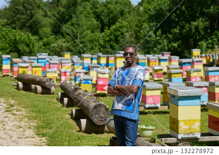 African American Teenager Exploring Small Beekeeping Businesses in Traditional Sudanese Attire amidst Nature 132278972