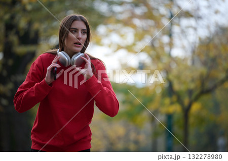 Athletic young woman taking a breath and relaxing after jogging and stretching. Woman Training and Workout Exercises On Street. Athletic young woman taking a breath and relaxing after jogging and stretching. Woman Training and Workout Exercises On Street. 132278980