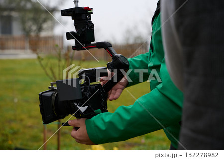 Videography team setting up the professional equipment and cameras for a high-quality music video shoot. Videography team setting up the professional equipment and cameras for a high-quality music video shoot. 132278982