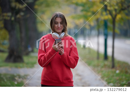 Athletic young woman taking a breath and relaxing after jogging and stretching. Woman Training and Workout Exercises On Street. 132279012