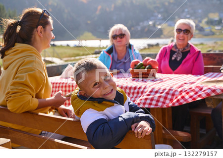 A family on a mountain vacation indulges in the pleasures of a healthy life, savoring traditional pie while surrounded by the breathtaking beauty of nature, fostering family bonds and embracing the A family on a mountain vacation indulges in the pleasures of a healthy life, savoring traditional pie while surrounded by the breathtaking beauty of nature, fostering family bonds and embracing the 132279157