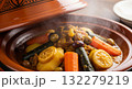 Steaming authentic Moroccan chicken or lamb tagine being prepared and served 132279219