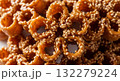 An extreme close-up, mouth-watering video of a stack of golden-brown Chebakia pastries, a traditional Maghrebi sweet. 132279224