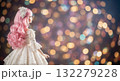 Magical photo. A doll in a white dress with pink hair stands with her back against a magical bokeh background 132279228