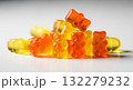 Close-up texture of orange and yellow multivitamin bears gummies in the form of bears on white background 132279232