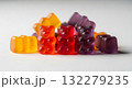 Group of red, orange and purple multivitamin gummies bears isolated on white background. Healthy lifestyle concept 132279235