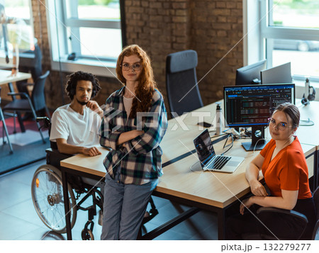 A diverse group of young business individuals congregates in a modern startup coworking center, embodying collaborative innovation and a dynamic atmosphere 132279277
