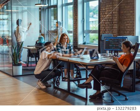 A diverse group of young business individuals congregates in a modern startup coworking center, embodying collaborative innovation and a dynamic atmosphere 132279283